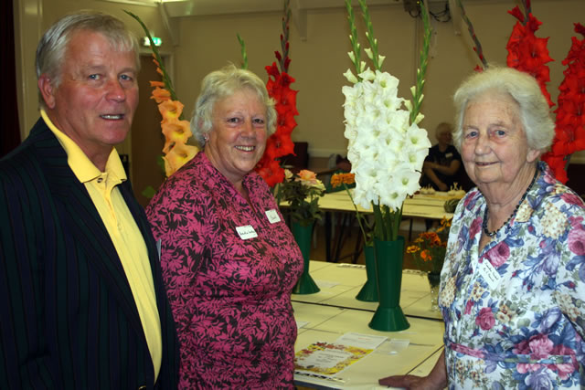 Show Co-ordinator Marcus Giles, Association Secretary Jane Finley and President Sylvia Pleasance admire the gladioli.